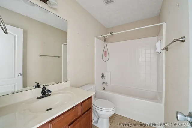 a bathroom with a sink mirror toilet and bathtub