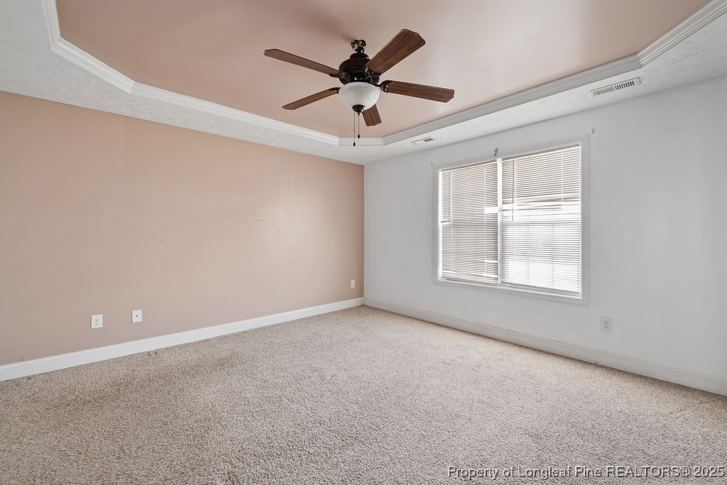 185 Sunflower Street Raeford, NC 28376 - Photo 19 of 30 an empty room with ceiling fan and windows