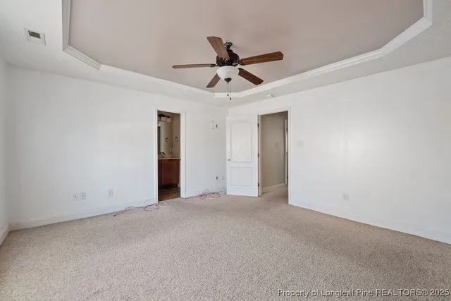 a view of an empty room with a ceiling fan