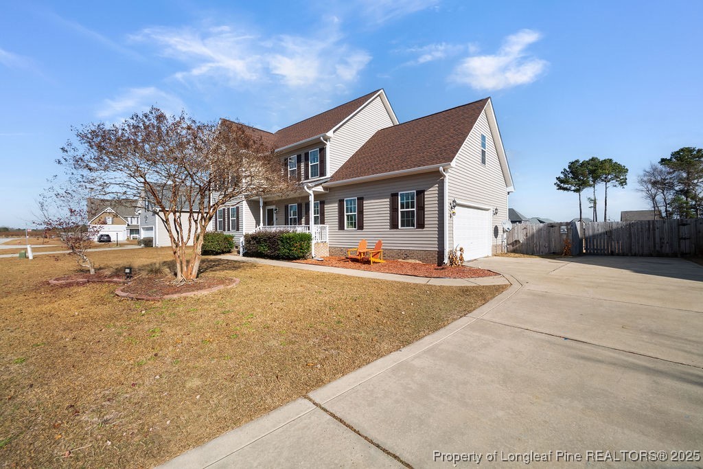 185 Sunflower Street Raeford, NC 28376 - Photo 2 of 30 a view of a white house with a yard covered in snow