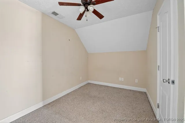a view of a room with a ceiling fan