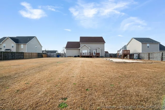 a view of house with yard and car parked