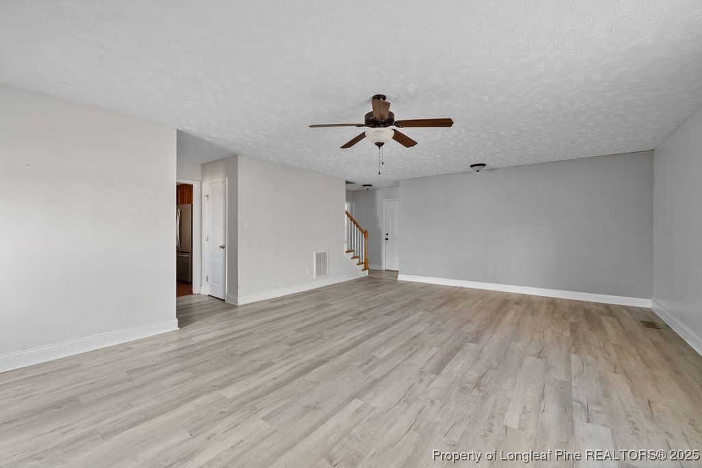 185 Sunflower Street Raeford, NC 28376 - Photo 7 of 30 a view of an empty room with wooden floor