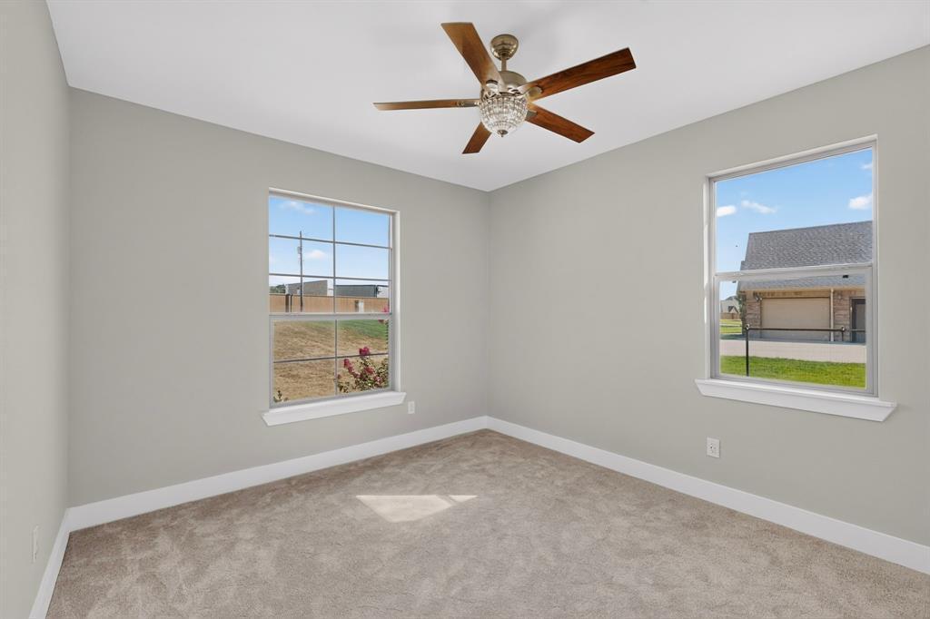 108 Winding Way Azle, TX 76020 - Photo 24 of 38 Neutral wall paint, plush carpeting, dual pane windows, and a decorative ceiling fan