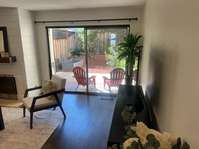 a view of backyard with outdoor seating and green space