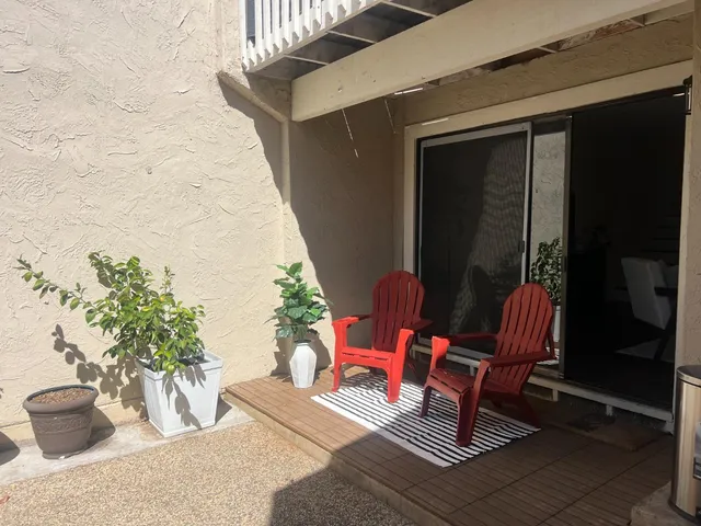 a wooden bench sitting in front of a building