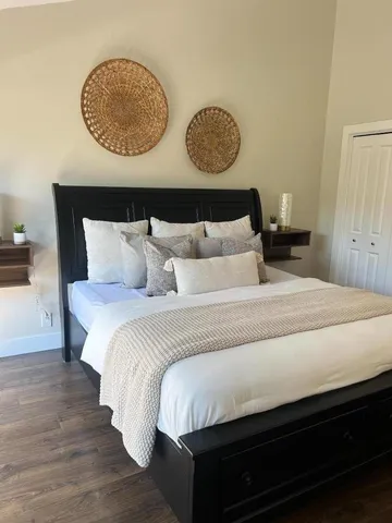 a bed sitting in a bedroom next to a window