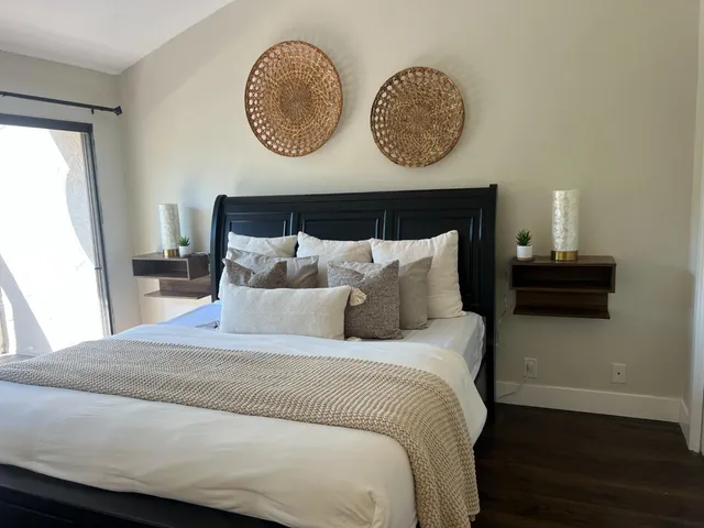a couple of flower plants sitting in balcony with wooden fence