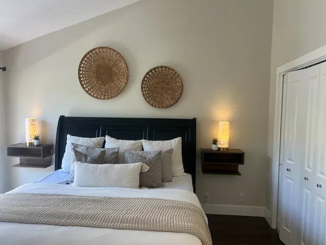 a view of a hallway with living room and wooden floor