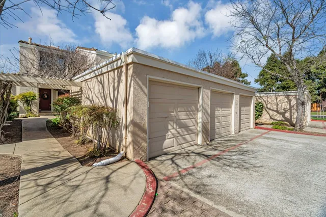 a view of a hallway with wooden floor windows and a livingroom