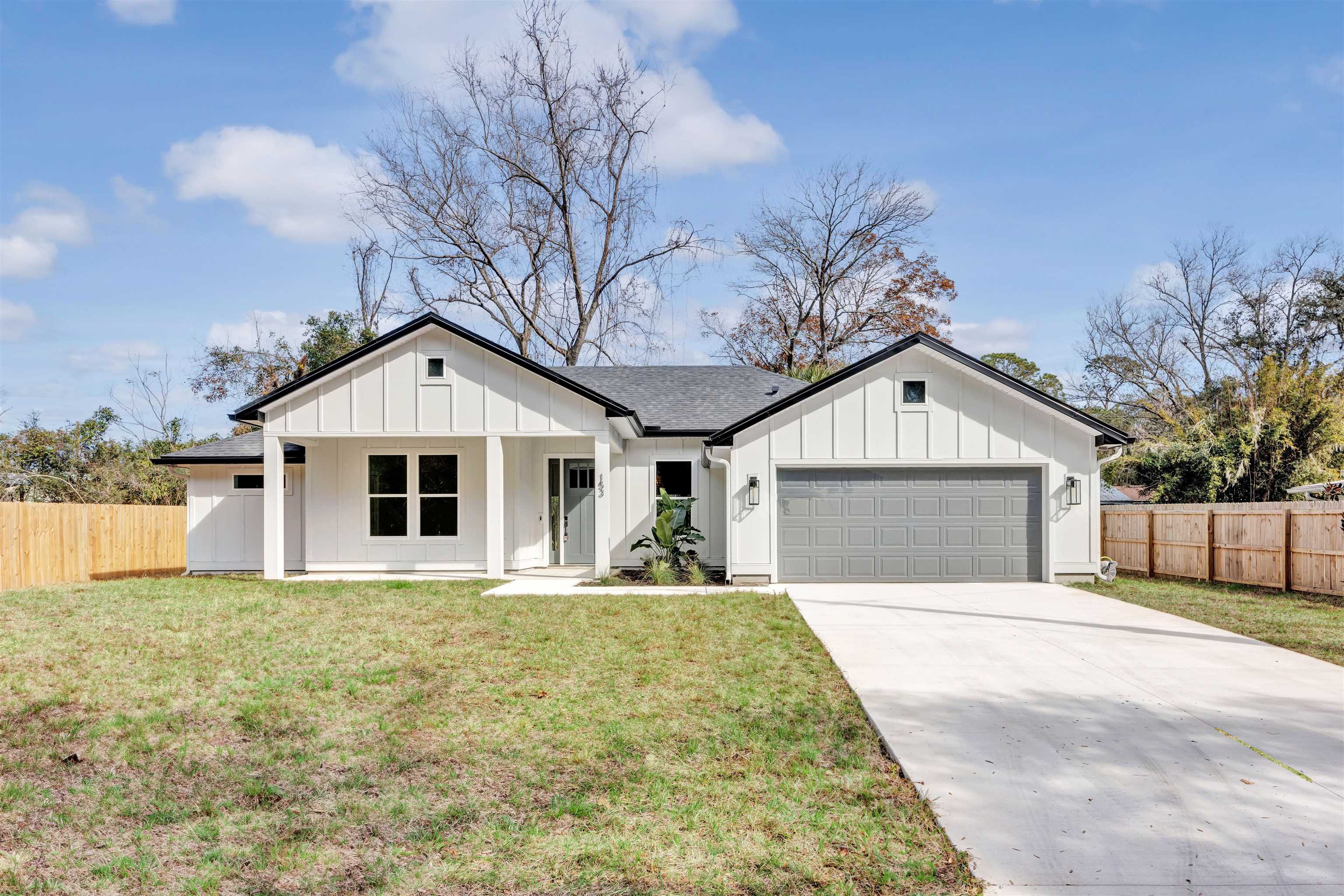 a front view of a house with yard and garage