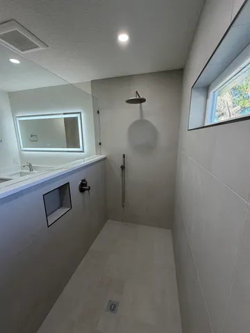 a room with a wooden floor and a large window