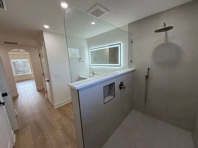 a kitchen with refrigerator cabinets and wooden floor