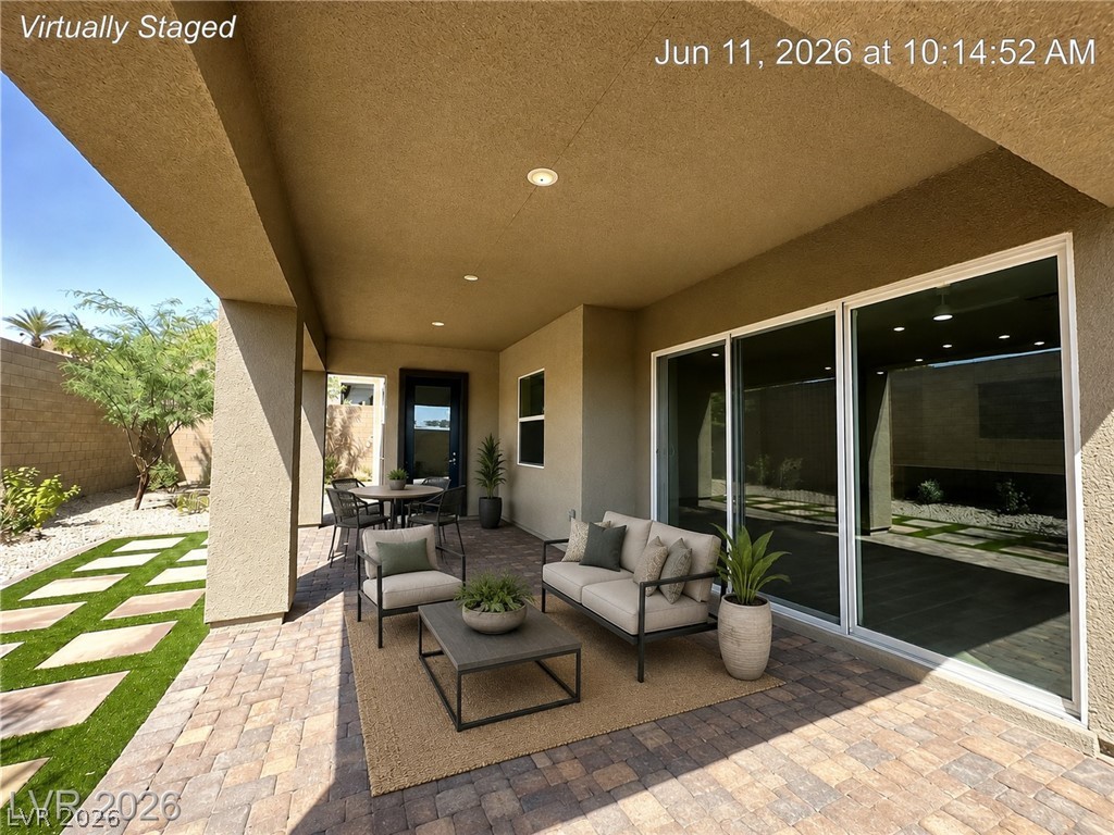 37 Charlotte Ridge Place Henderson, NV 89011 - Photo 3 of 44 An inviting covered patio with brick pavers extends to a landscaped private yard. *Virtually Staged*