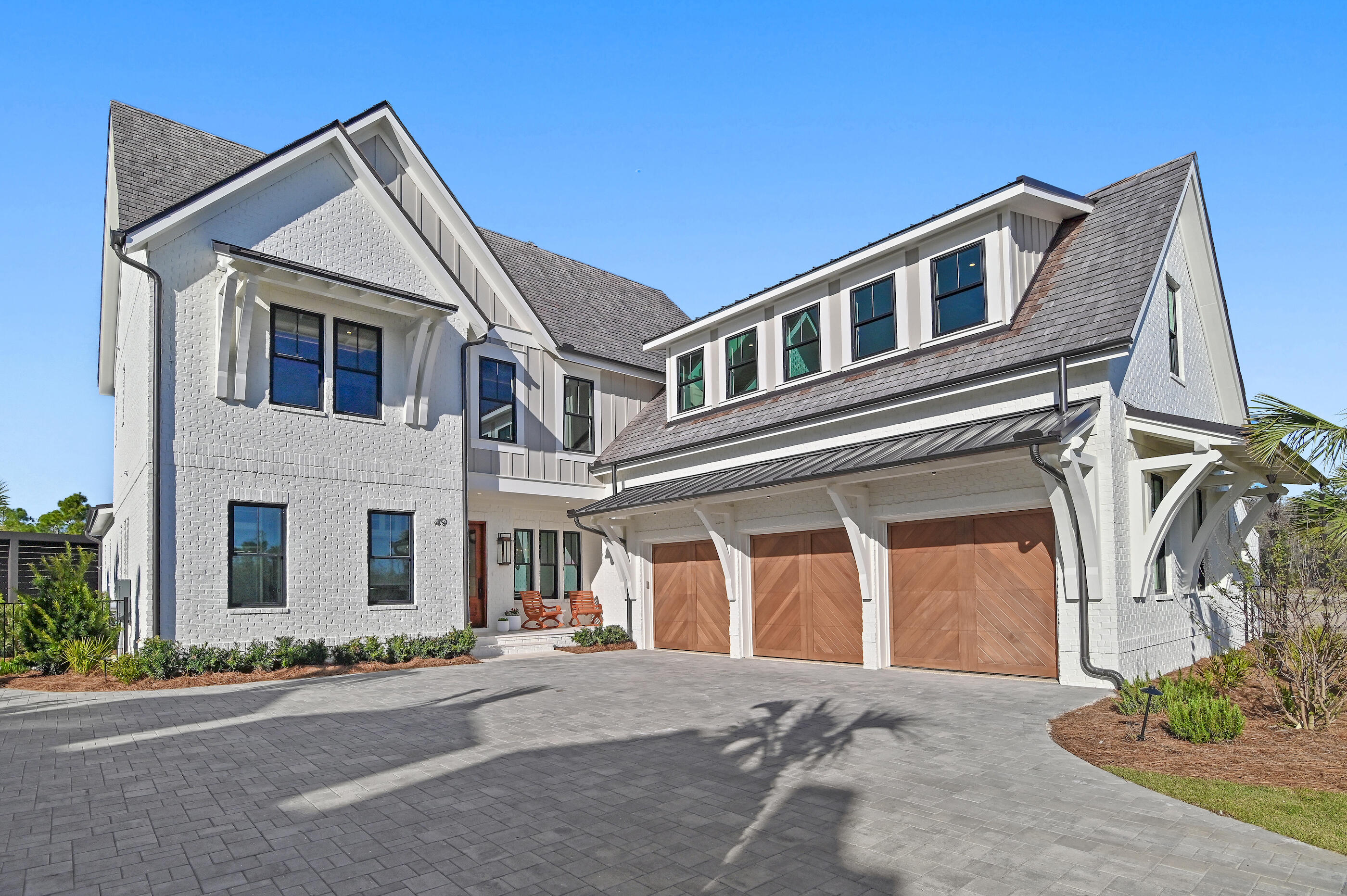 49 Sundew Pl Inlet Beach Inlet Beach, FL 32461 - Photo 96 of 108 a front view of a house with a yard and garage