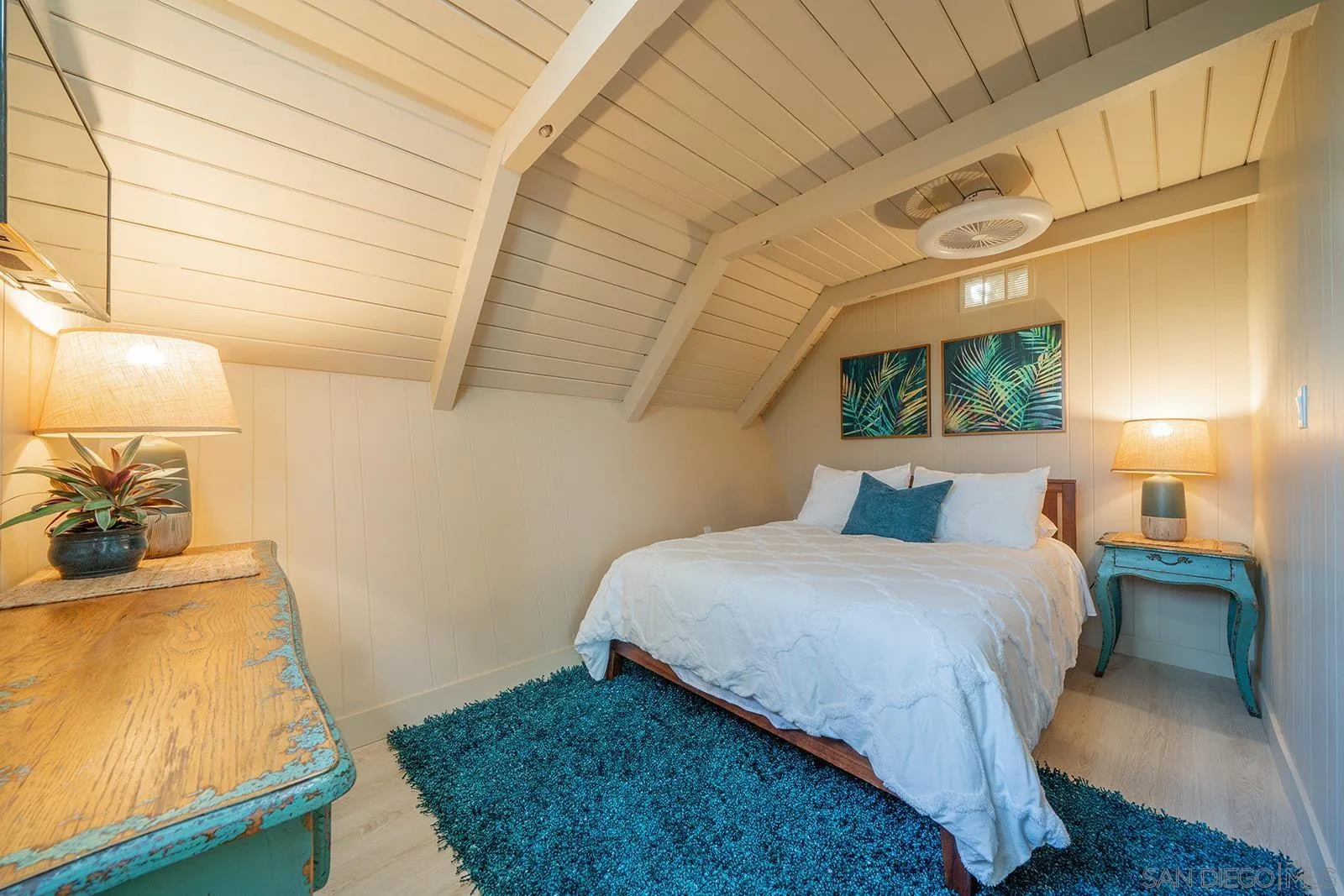 843 Neptune Avenue Encinitas, CA 92024 - Photo 17 of 49 a bedroom with a bed and wooden floor