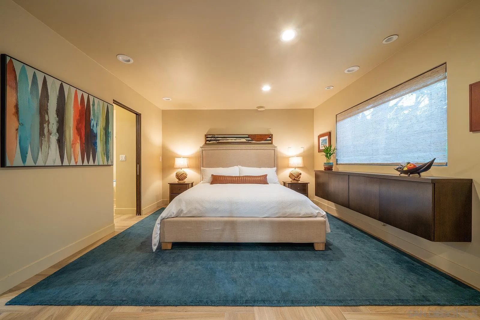 843 Neptune Avenue Encinitas, CA 92024 - Photo 4 of 49 a spacious bedroom with a bed and a flat screen tv