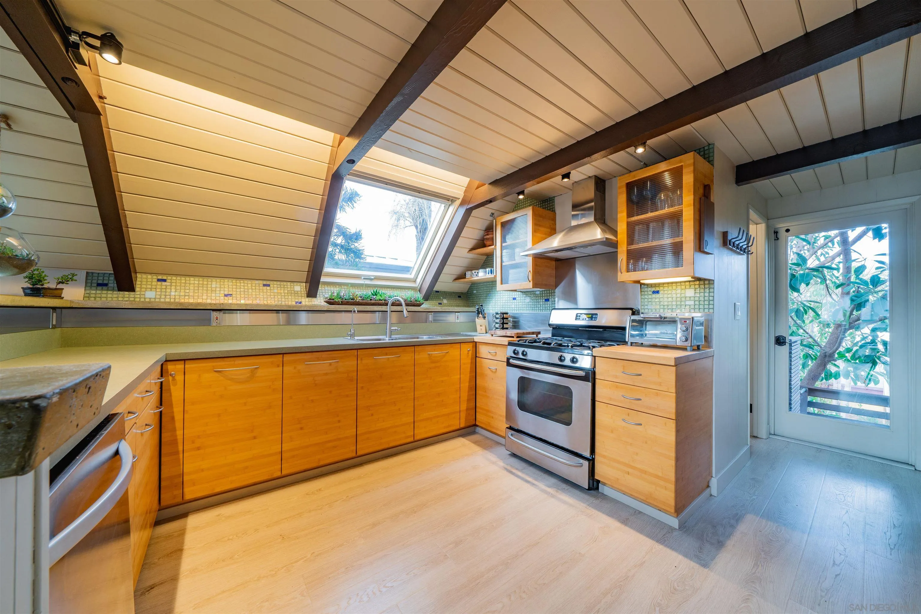 843 Neptune Avenue Encinitas, CA 92024 - Photo 7 of 49 a kitchen with stainless steel appliances granite countertop a stove a sink and a refrigerator