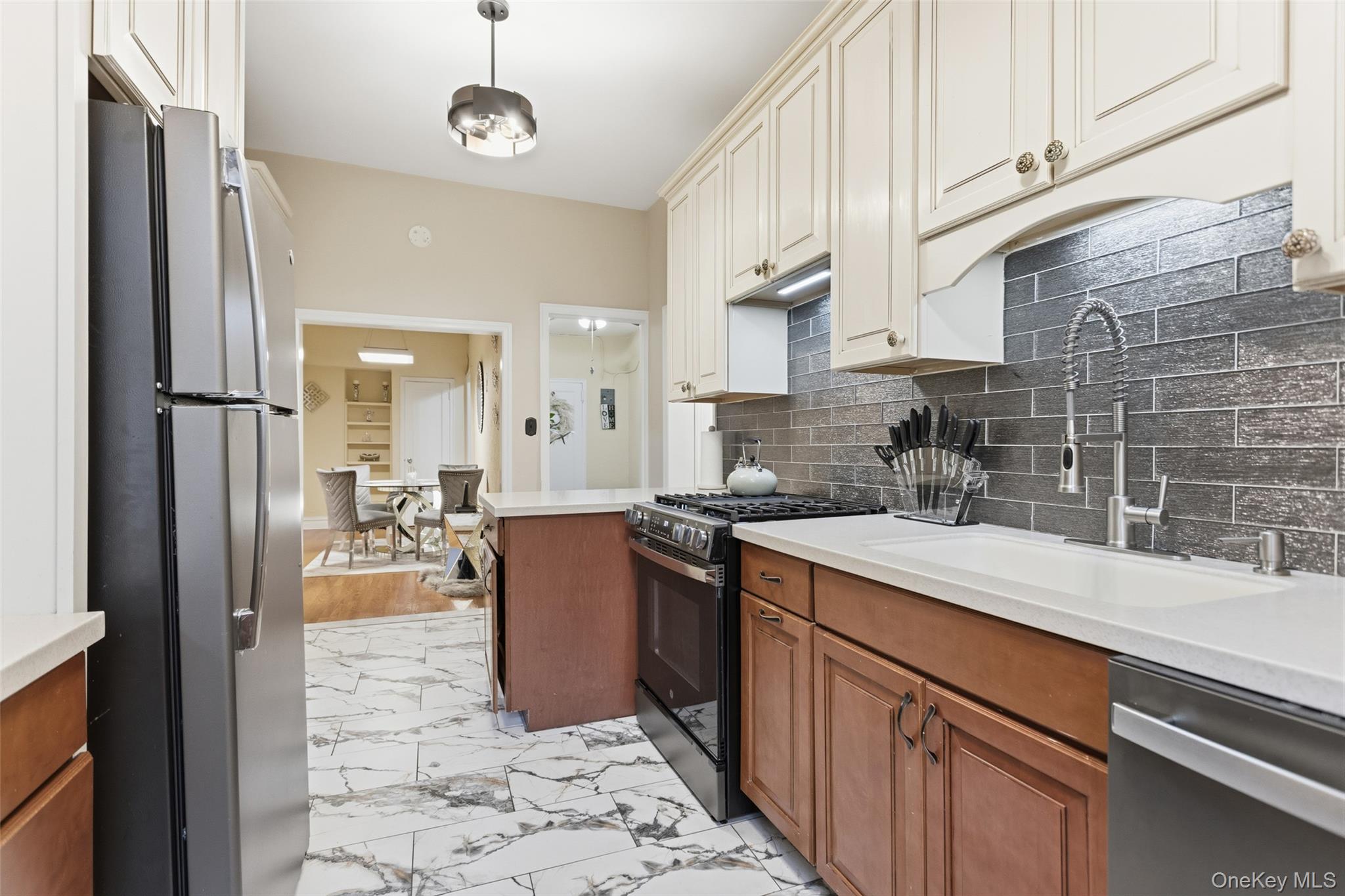 30 Clinton Place, Unit LB New Rochelle, NY 10801 - Photo 3 of 17 a kitchen with stainless steel appliances granite countertop a sink a stove refrigerator and cabinets