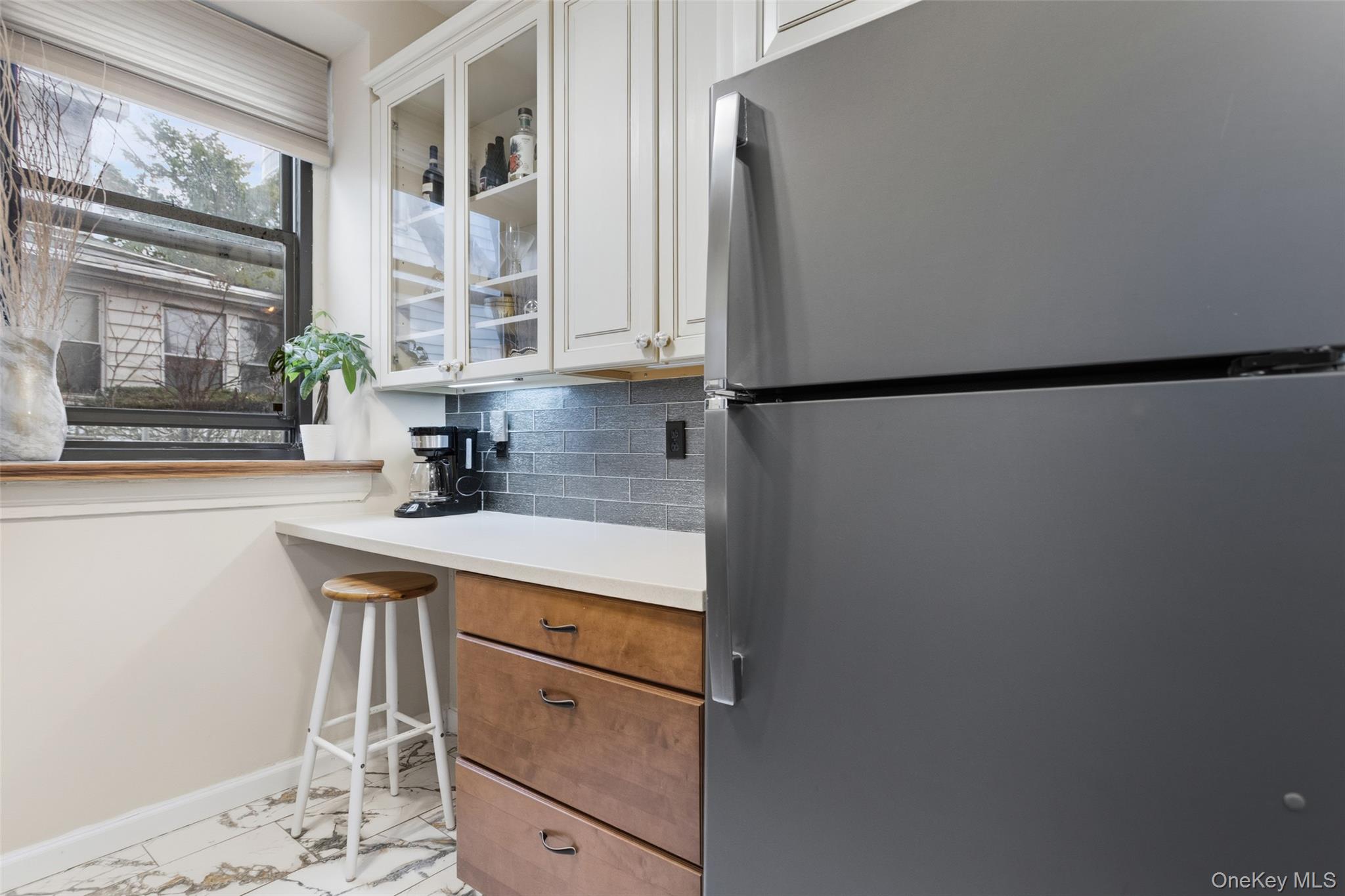 30 Clinton Place, Unit LB New Rochelle, NY 10801 - Photo 4 of 17 a kitchen with stainless steel appliances a refrigerator and a sink