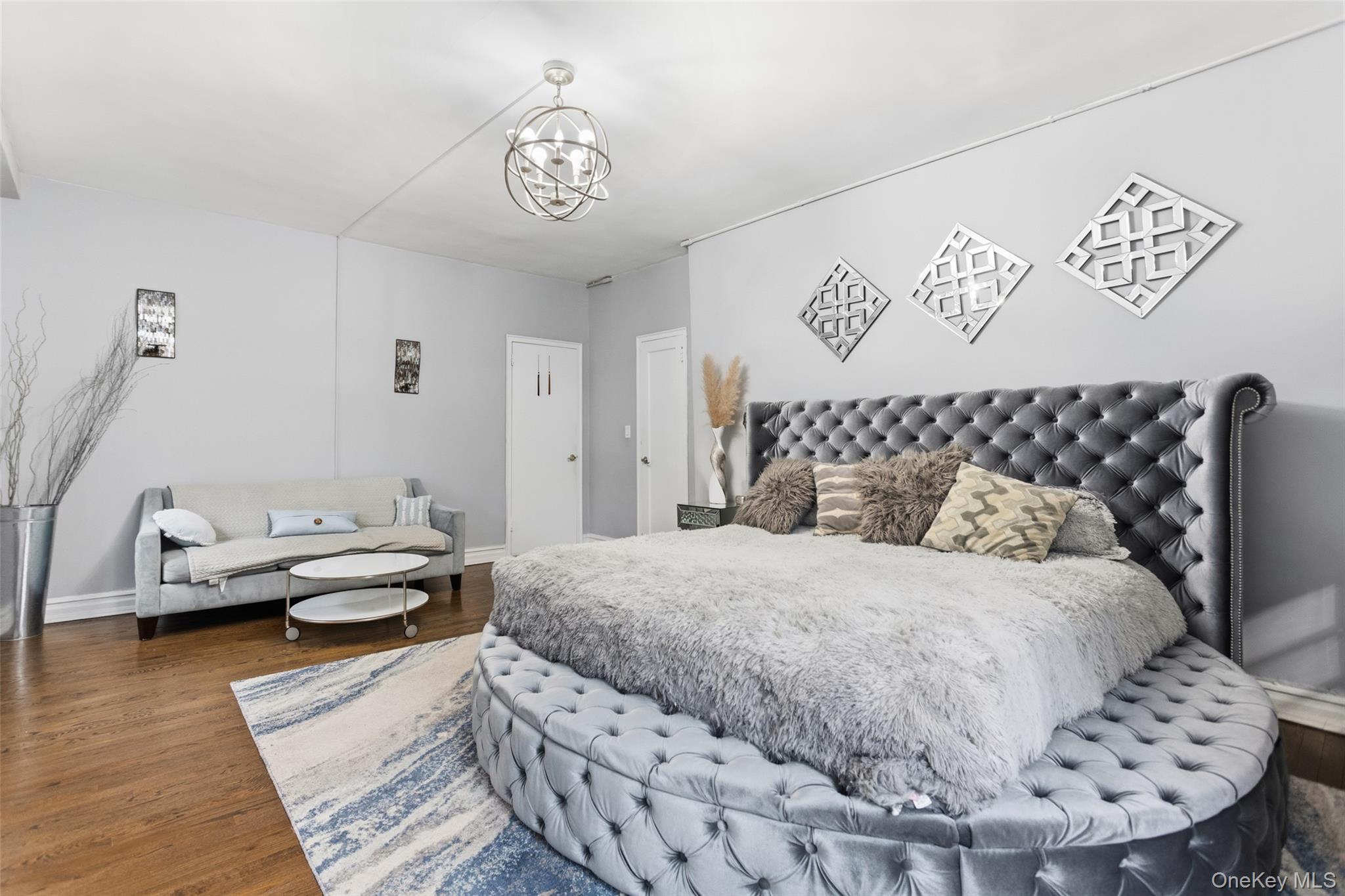 30 Clinton Place, Unit LB New Rochelle, NY 10801 - Photo 8 of 17 a bedroom with a bed and wooden floor