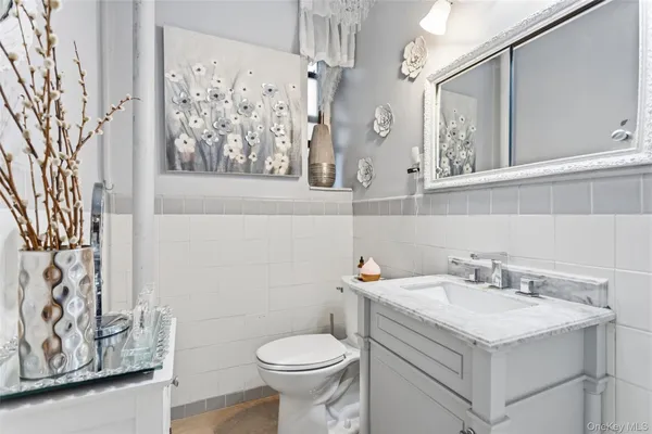 a bathroom with a sink and mirror with toilet