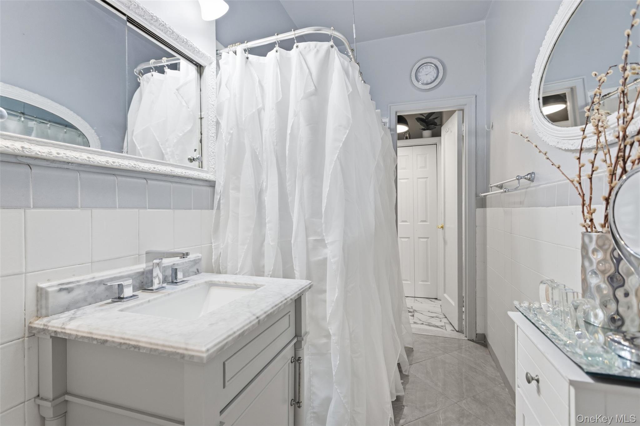 30 Clinton Place, Unit LB New Rochelle, NY 10801 - Photo 10 of 17 a bathroom with a sink and a mirror
