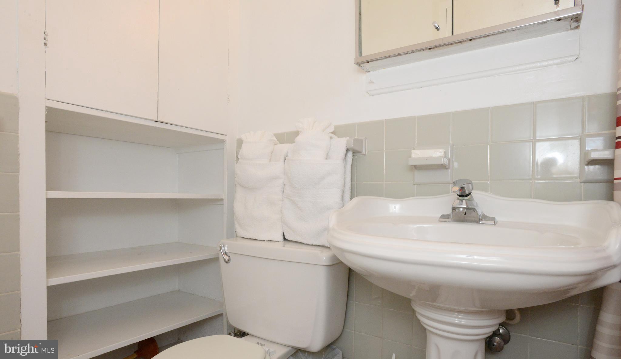 1021 Arlington Boulevard, Unit 336 Arlington, VA 22209 - Photo 9 of 25 BATH ROOM BUILT-IN LINEN CLOSET & SHELVING