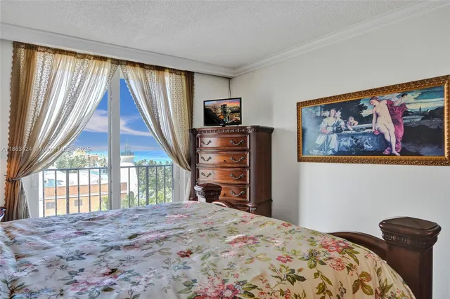 a bedroom with a bed and a television