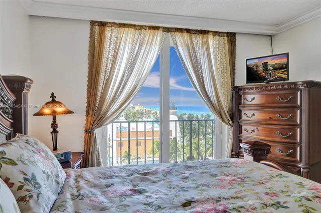 a bathroom with a granite countertop sink a mirror and a toilet
