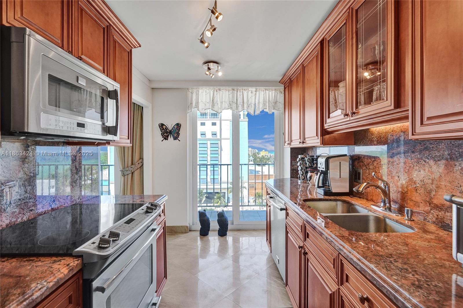 322 Buchanan Street, Unit 810 Hollywood, FL 33019 - Photo 19 of 46 a kitchen that has a lot of cabinets in it