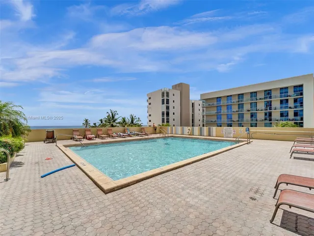 a view of a balcony with wooden floor and fence
