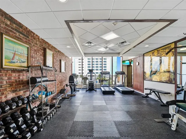 a room with furniture pool table and a wooden floor