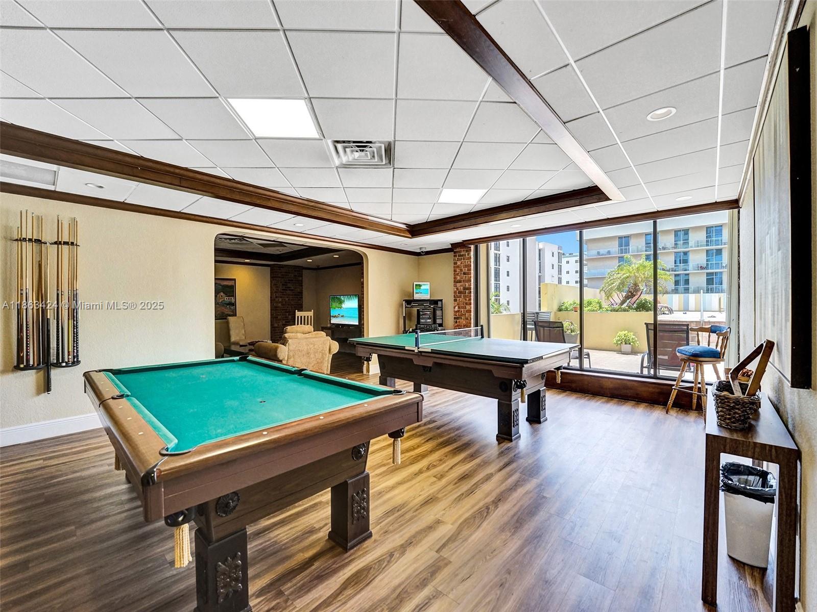 322 Buchanan Street, Unit 810 Hollywood, FL 33019 - Photo 32 of 46 a room with furniture pool table and a wooden floor