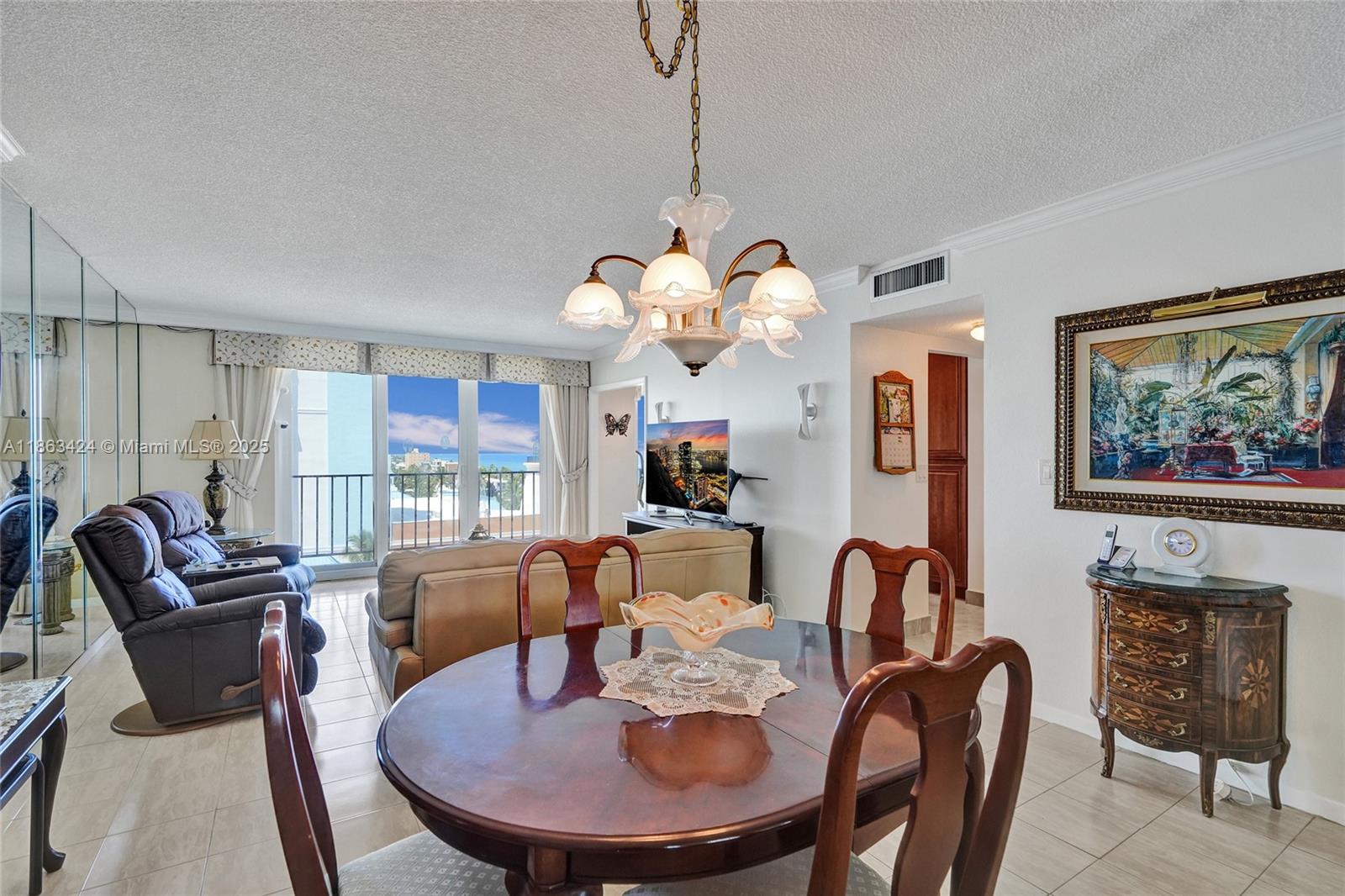 322 Buchanan Street, Unit 810 Hollywood, FL 33019 - Photo 8 of 46 a view of a dining room with furniture a chandelier and wooden floor