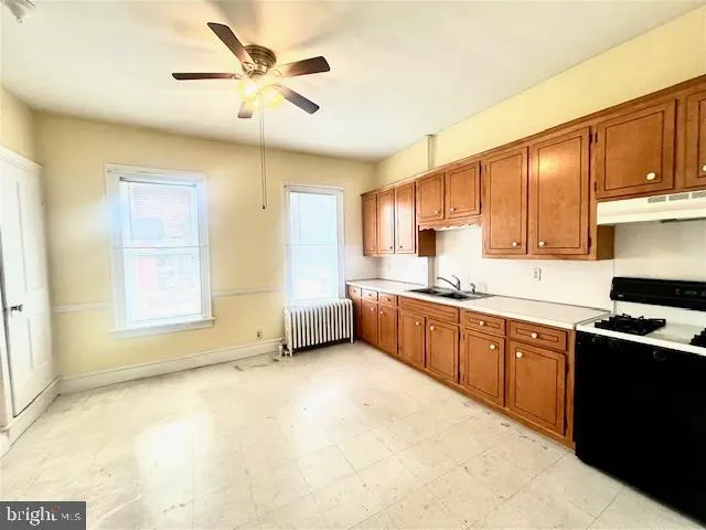 a kitchen with stainless steel appliances granite countertop a sink cabinets and window