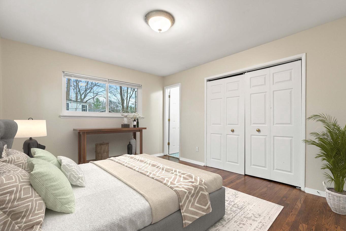 6505 Farley Street Springfield, VA 22152 - Photo 13 of 30 a bedroom with a large bed and a chandelier