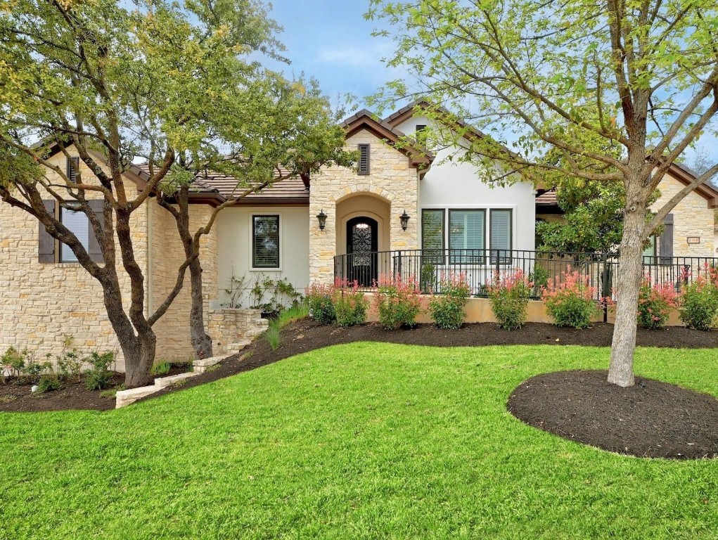 a front view of a house with garden