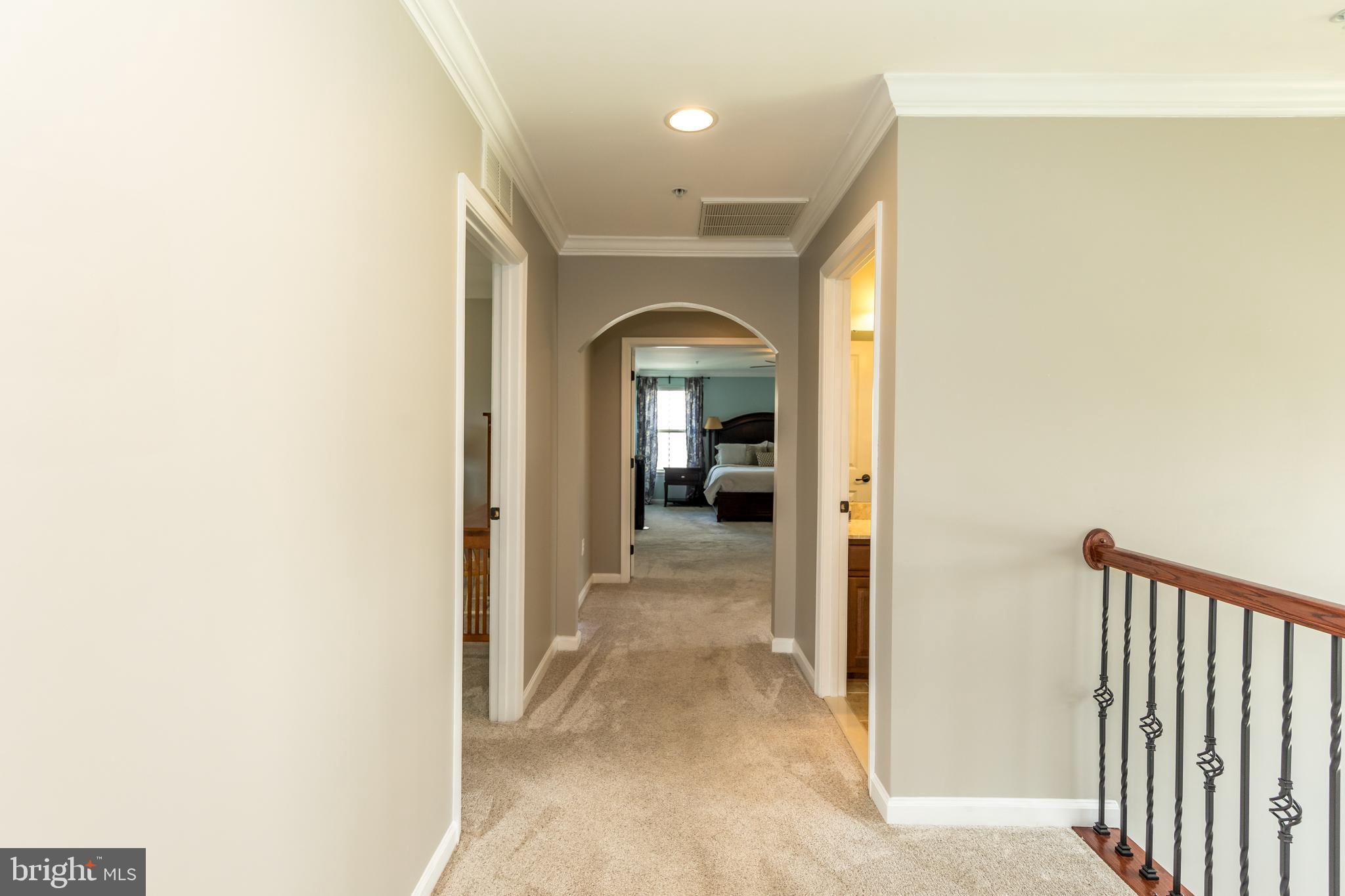 10415 Windlass Run Road Baltimore, MD 21220 - Photo 20 of 52 a view of a hallway with wooden floor and a bathroom