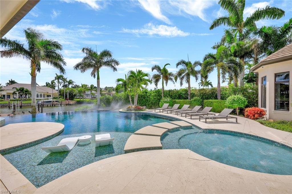 850 Nelson`s Walk Naples, FL 34102 - Photo 12 of 47 a view of a swimming pool and lounge chairs