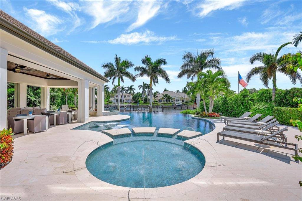 850 Nelson`s Walk Naples, FL 34102 - Photo 13 of 47 a view of a swimming pool with lounge chair