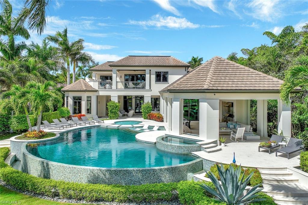 850 Nelson`s Walk Naples, FL 34102 - Photo 2 of 47 a view of a house with swimming pool and sitting area