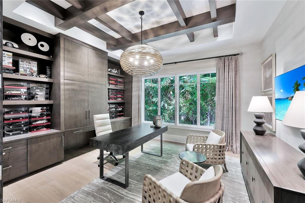 850 Nelson`s Walk Naples, FL 34102 - Photo 26 of 47 a living room with furniture a chandelier and a large window
