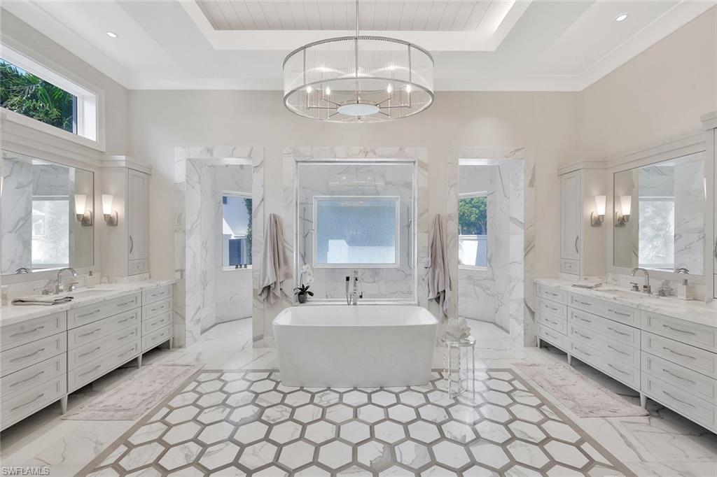 850 Nelson`s Walk Naples, FL 34102 - Photo 28 of 47 a spacious bathroom with a double vanity sink mirror and a bathtub