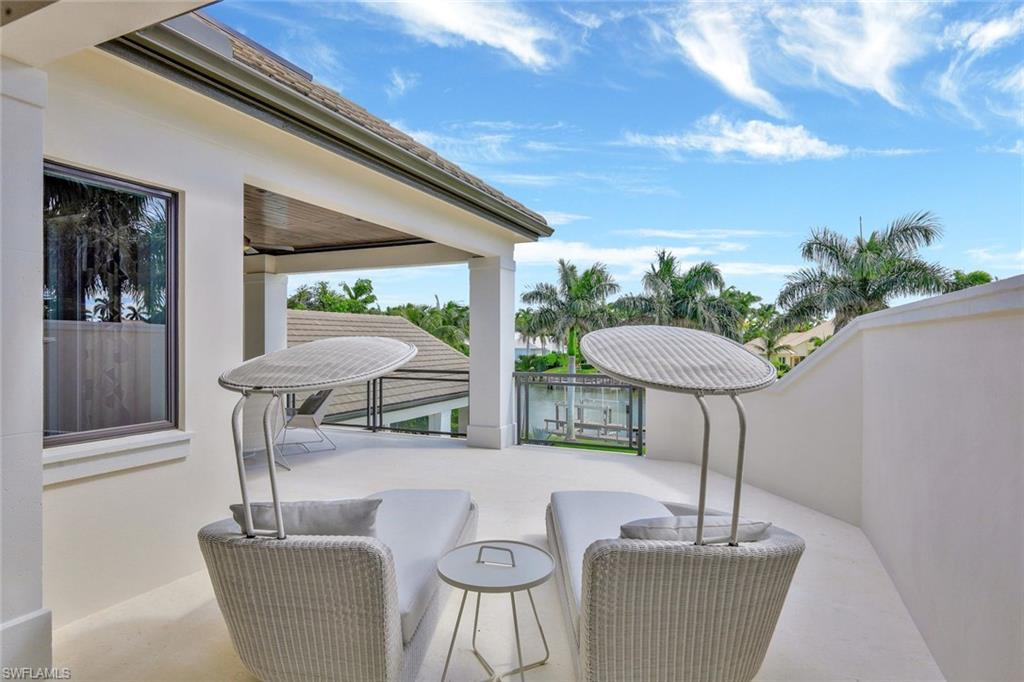 850 Nelson`s Walk Naples, FL 34102 - Photo 35 of 47 a table and chairs in a patio