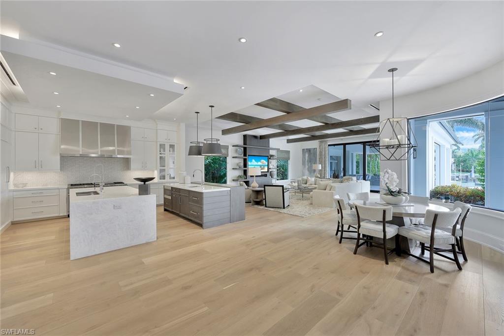 850 Nelson`s Walk Naples, FL 34102 - Photo 6 of 47 a large white kitchen with a table and chairs