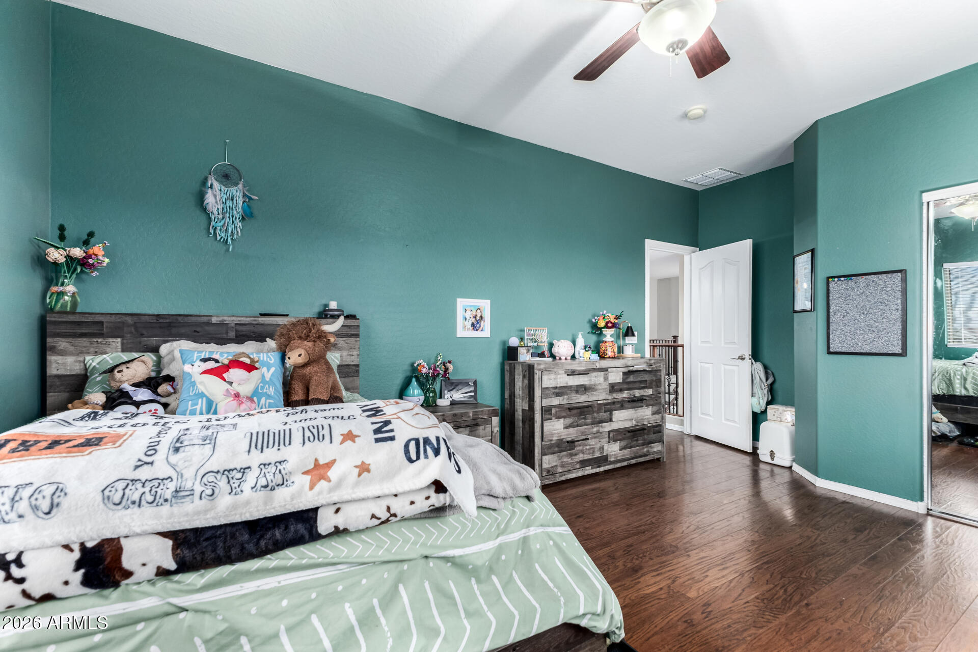 24541 Plum Road Florence, AZ 85132 - Photo 29 of 47 a bedroom with a bed and wooden floor