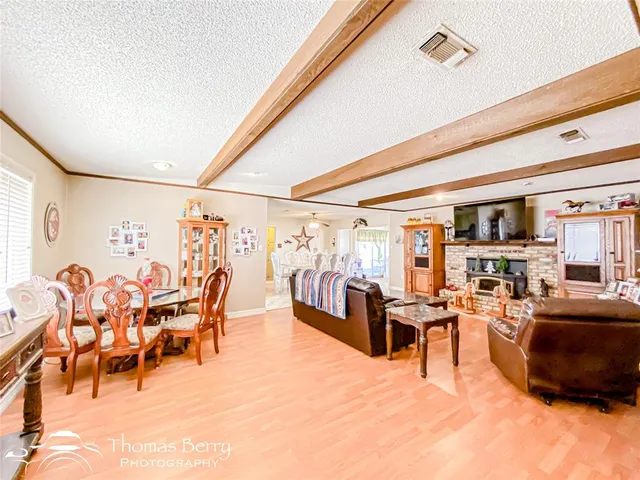 a living room with lots of furniture and a large window