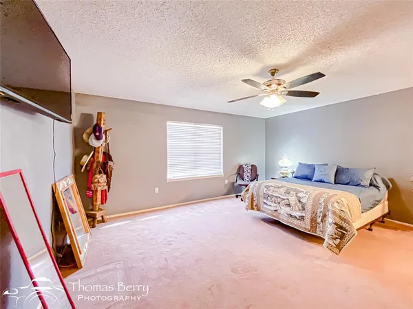 a bed room with a bed and a chandelier