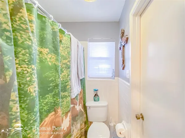 a white toilet sitting next to a bathroom sink